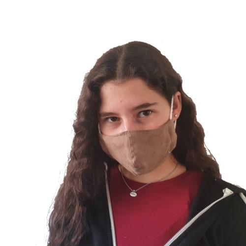 A teenage girl wearing a brown suede fabric face mask.