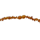 A teething necklace made up of small beads of different shapes. The beads are multi-colour. This image shows the clasp of the necklace.