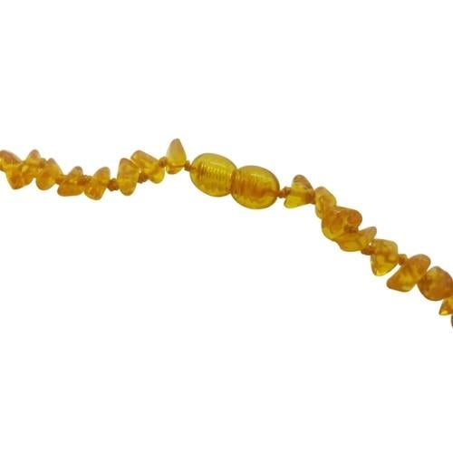 A teething necklace made up of small beads of different shapes. The beads have a golden colour. This image shows the clasp of the necklace.