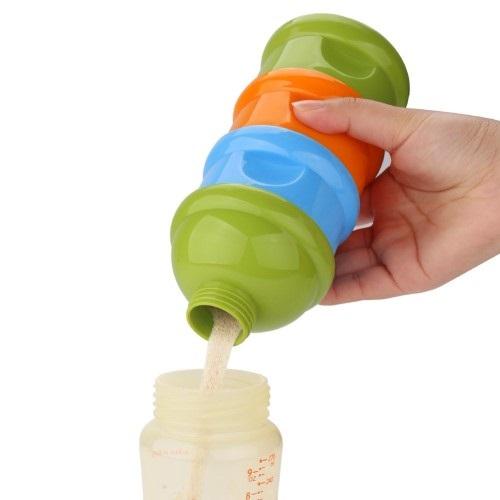 A ladies hand holding the milk powder dispenser pouring the powder into the baby bottle.