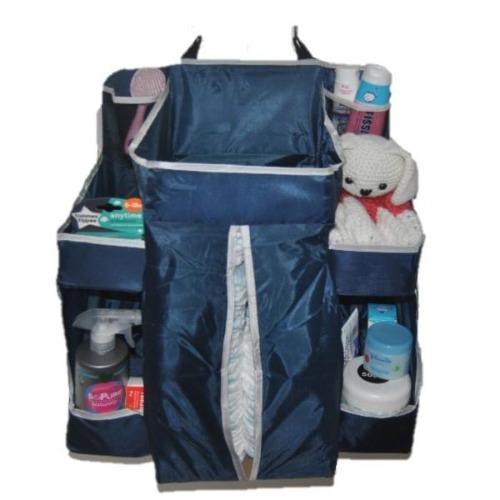 A navy nursery organizer filled with nappies, creams, wet wipes and a plush teddy.