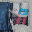 A close up view of the navy nursery organizer with bum creams in the pocket.