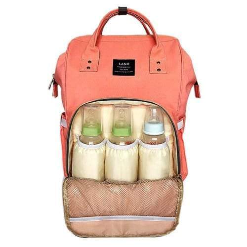 A peach backpack nappy bag. The front pocket is open. It has 3 baby bottles inside.