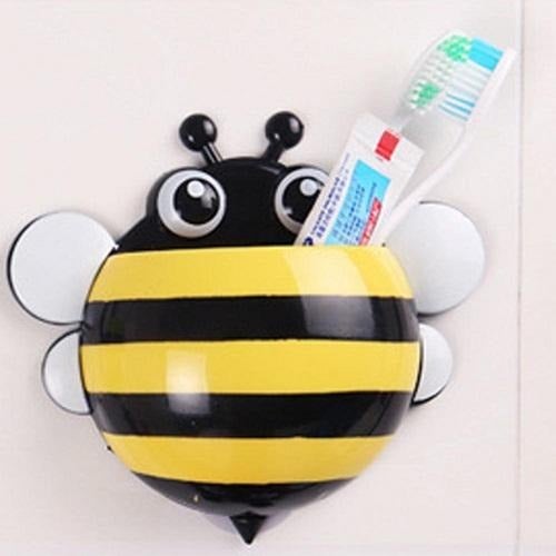 Toothbrushes and toothpaste in a Yellow Bee Toothbrush Holder.