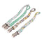 There are 4 braided pacifier clips in gree, white, grey and yellow colours. The pacifier clips have metal brace clips attached.