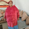 Lady wearing a maroon oversized hoodie blanket